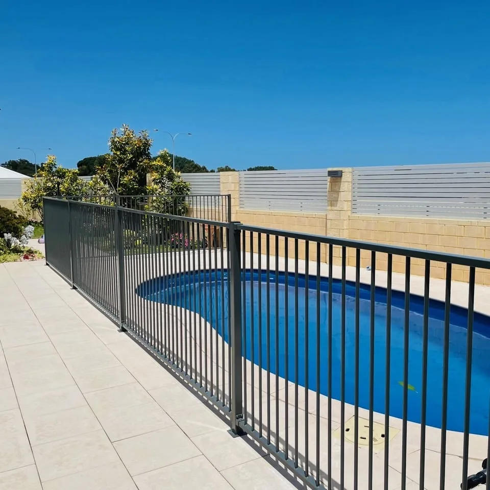 Grey aluminium pool fencing around a home pool
