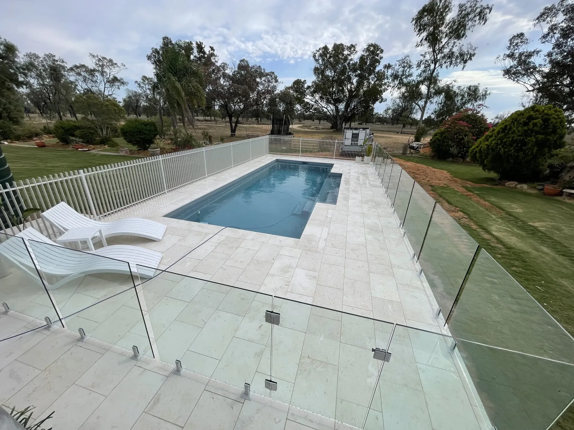 Aluminium and glass pool fencing around a pool on a rural property