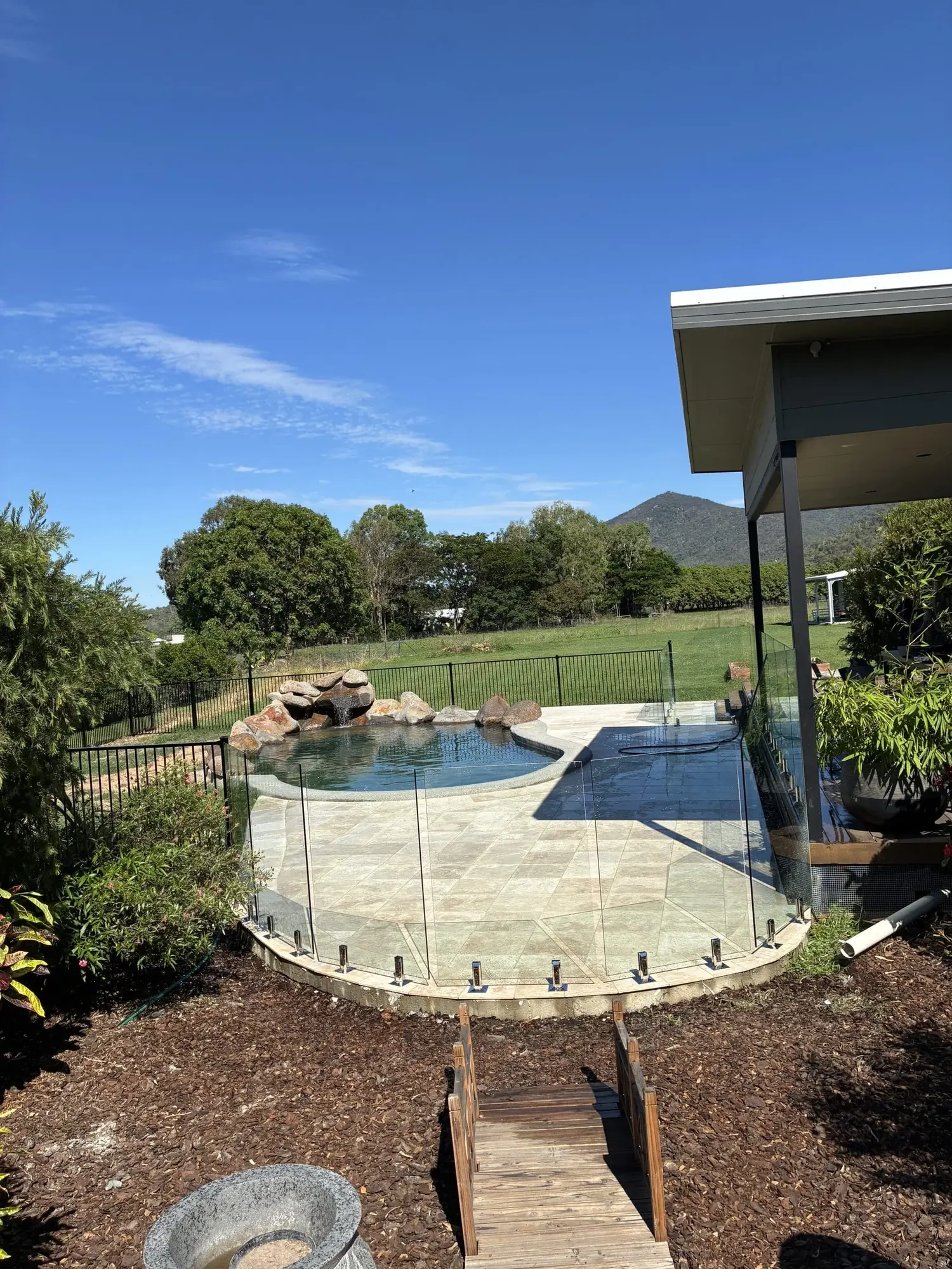 Frameless glass pool fence along a beachfront pool overlooking the ocean