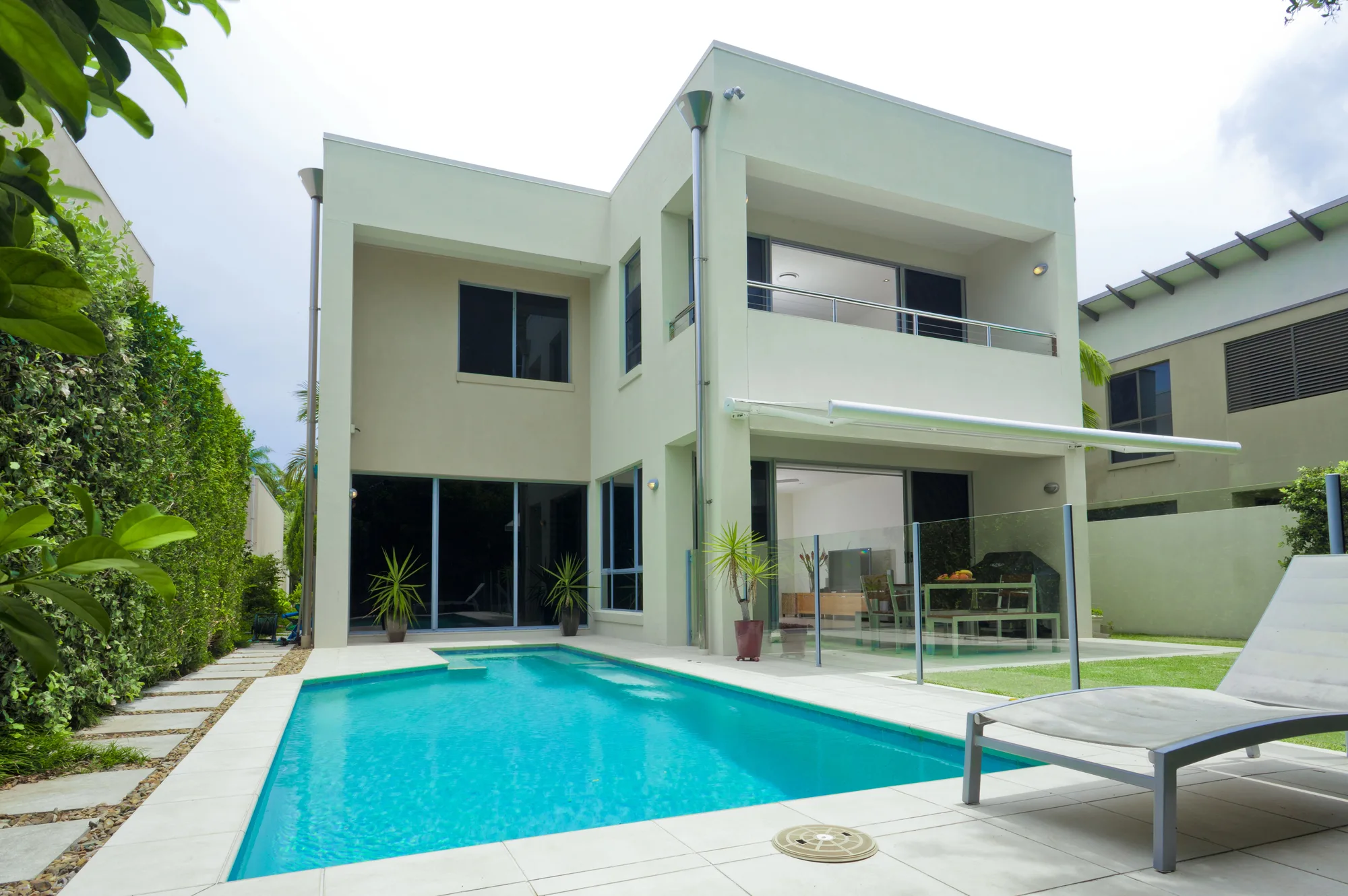 Modern two-storey home with a glass-fenced pool