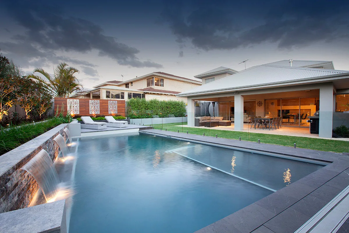 Pool with a waterfall feature and glass balustrade wall